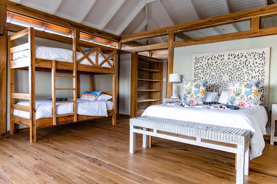 Bedroom with fish-print cushions and coastal palette