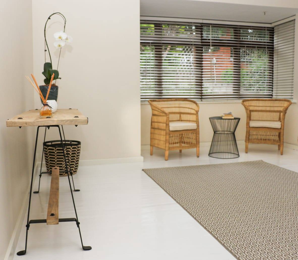Bedroom corner with rattan chair and natural light