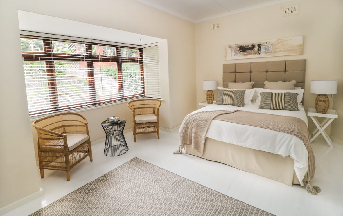 Serene bedroom with upholstered headboard and soft tones