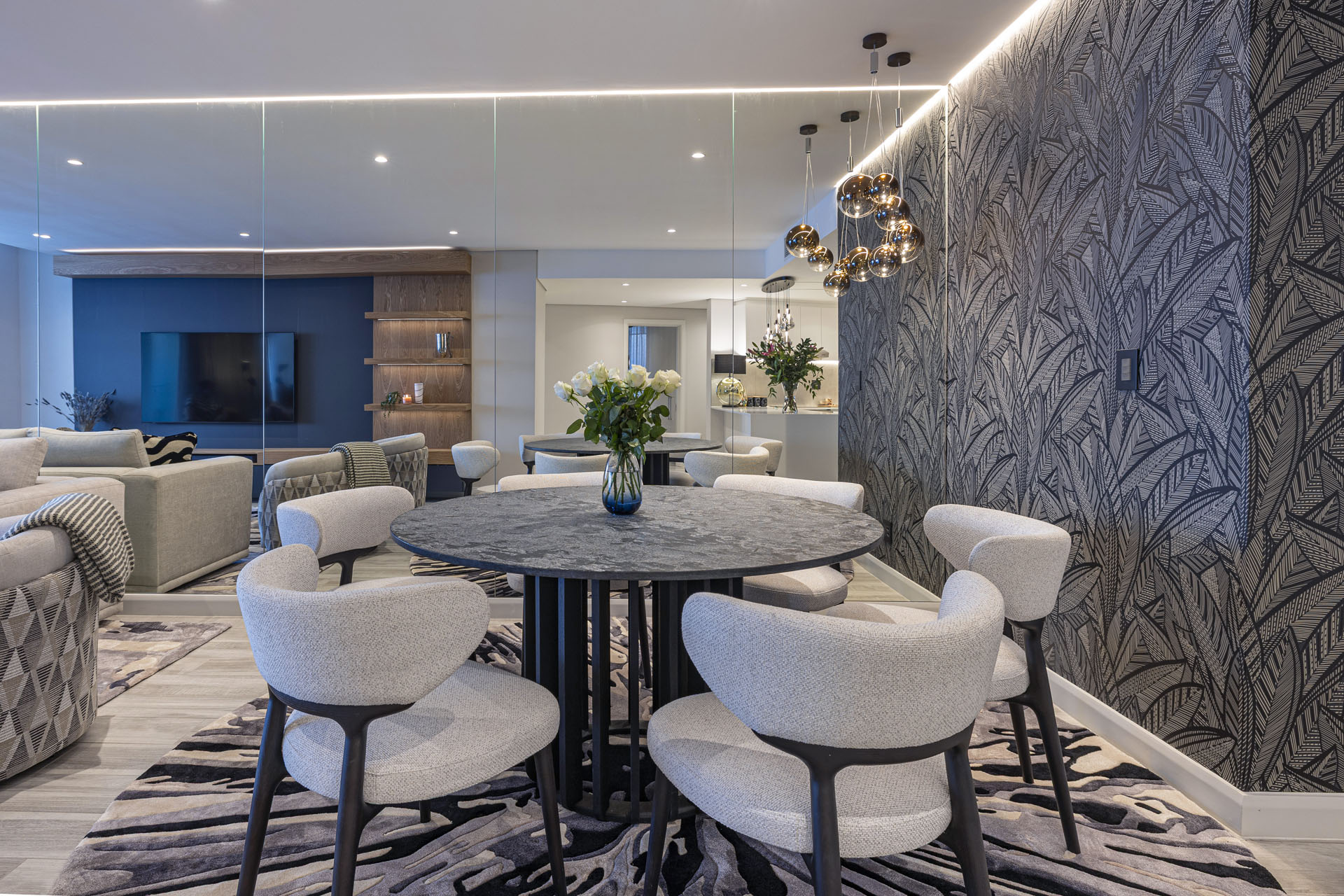 Dining room with round marble table and globe pendants