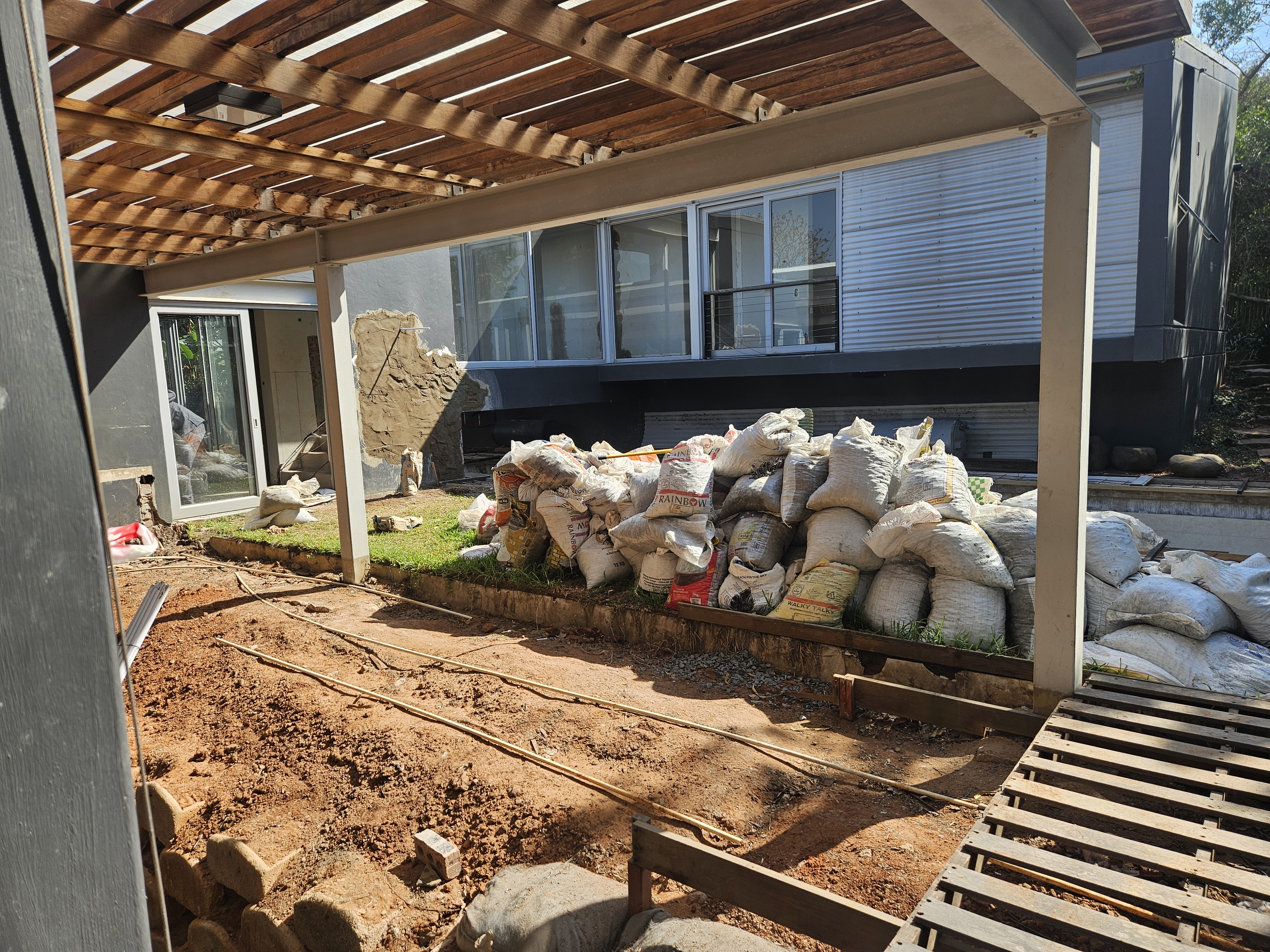 Garden and pergola area during full residential renovation with new ground works and drainage in progress