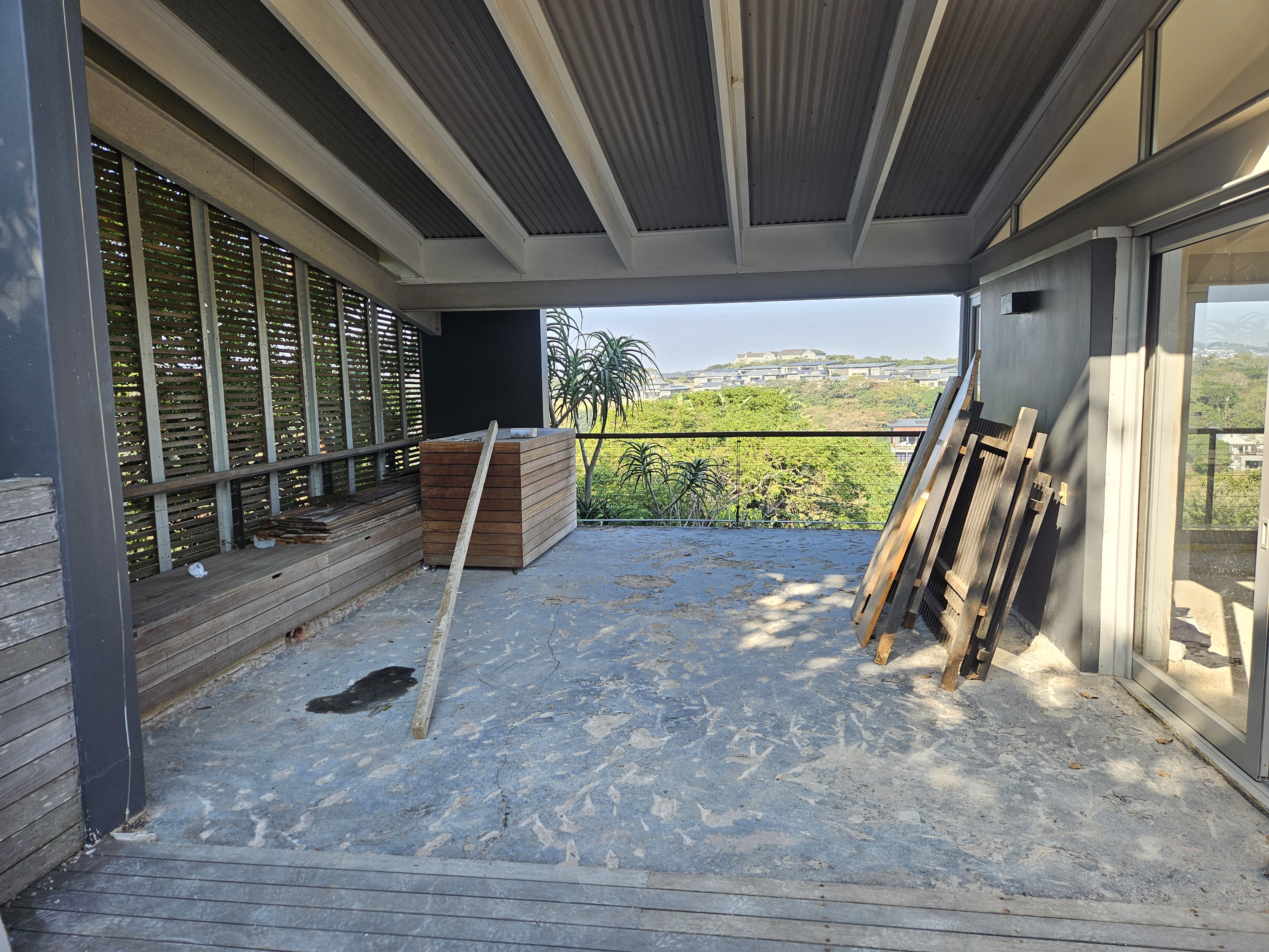 Covered balcony deck renovation with timber screening and coastal views in KwaZulu-Natal estate