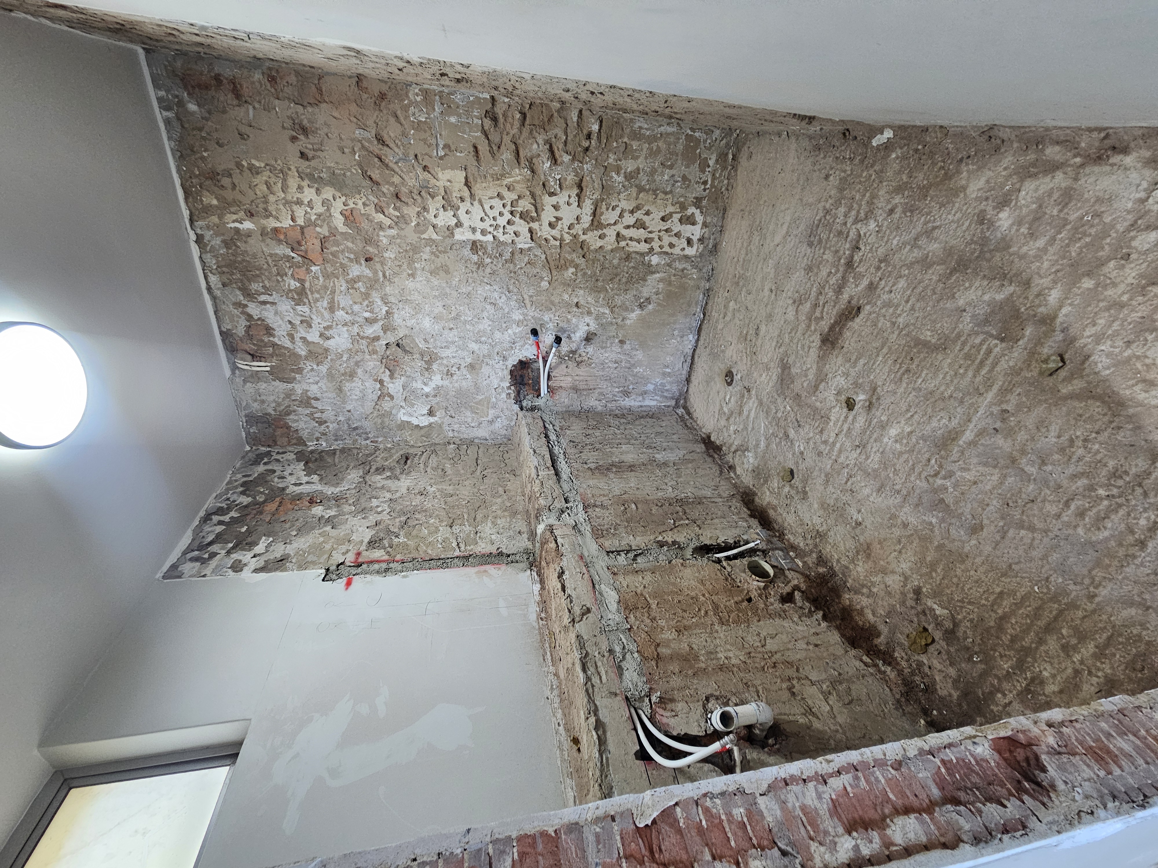 En-suite bathroom gutted for luxury renovation with new plumbing roughed in by Durban interior design studio
