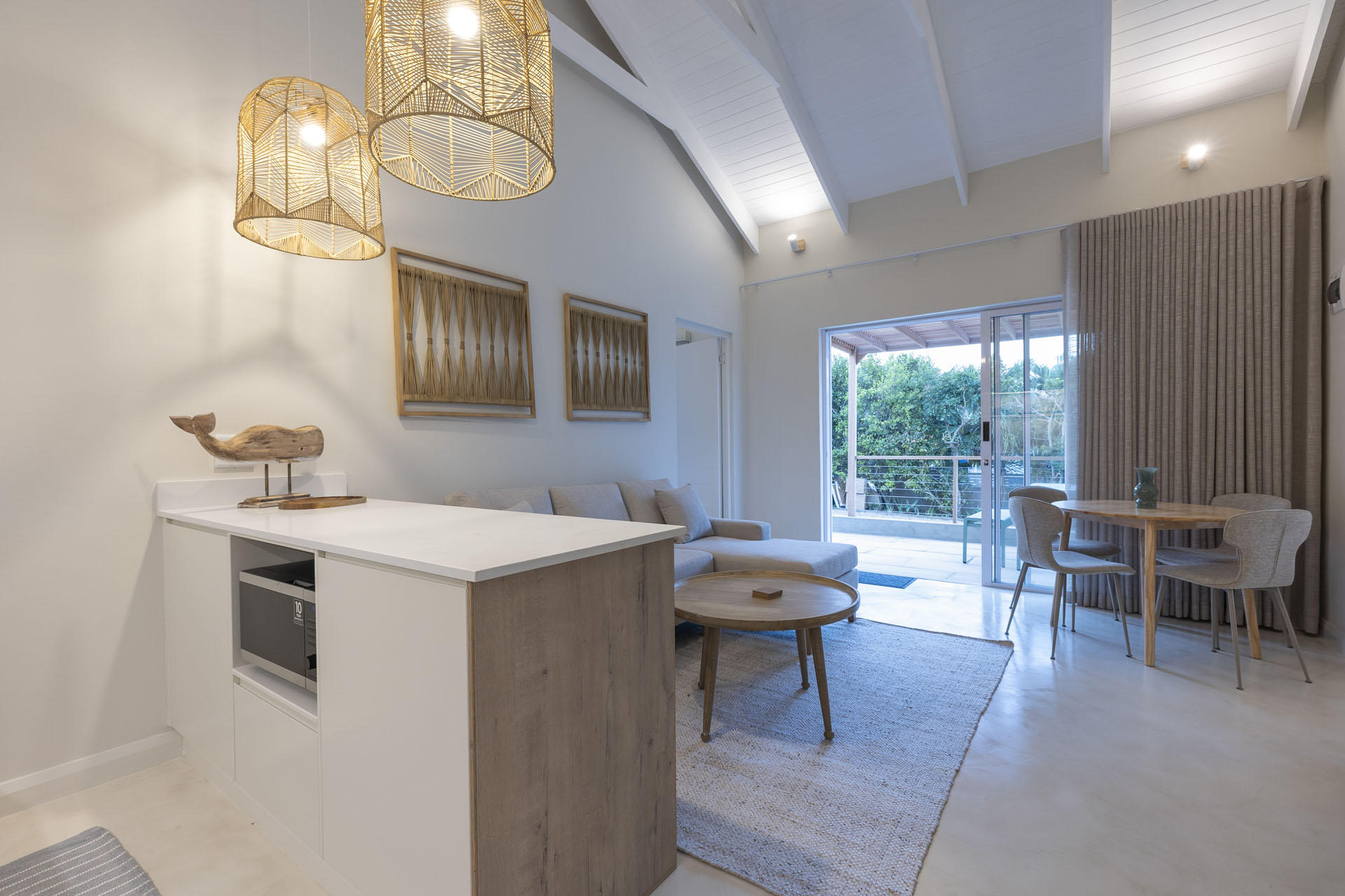 Dining room with rattan pendant lights and high ceilings